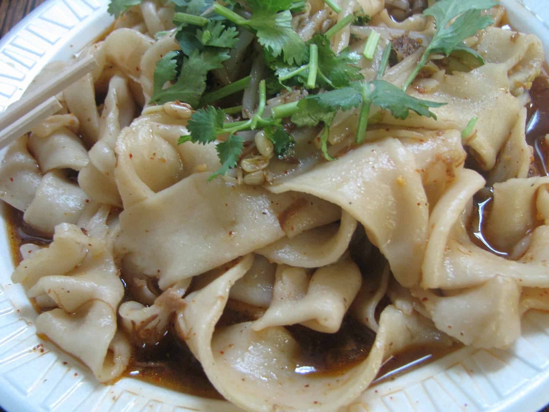 Biangbiang noodles: wide hand-pulled belt noodles with cilantro