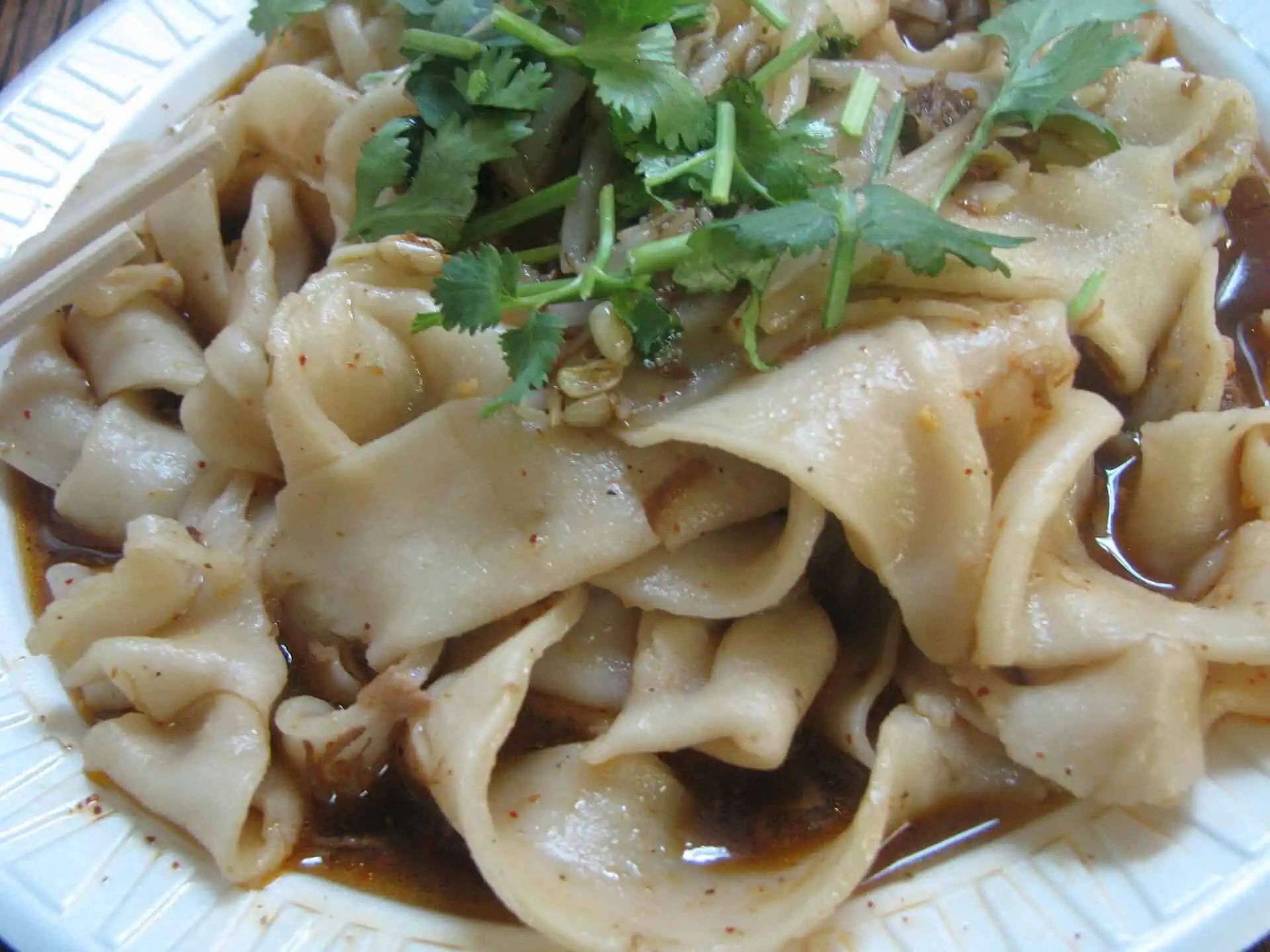 Biangbiang noodles: wide hand-pulled belt noodles with cilantro