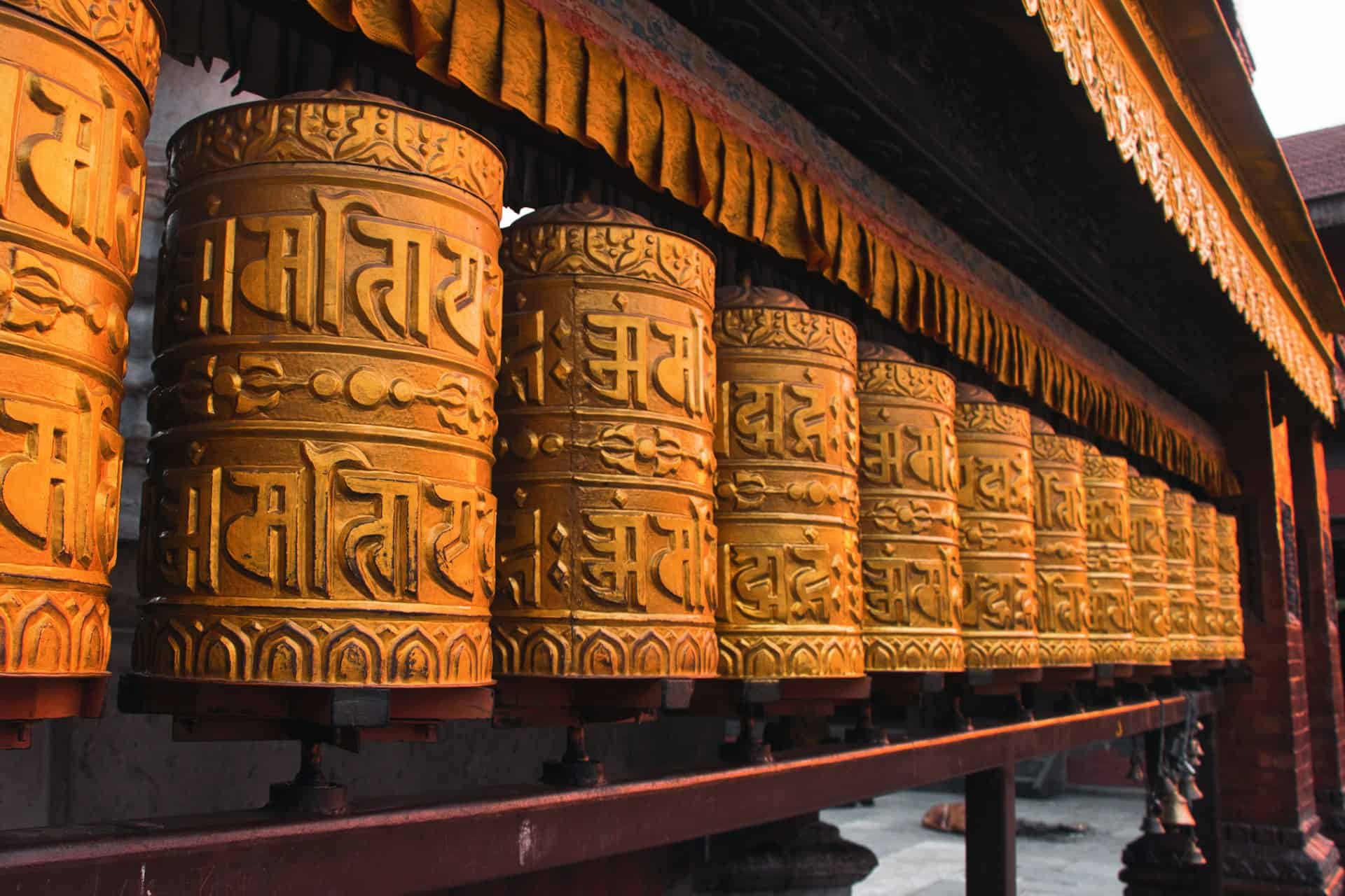 Rows of golden Tibetan prayer wheels