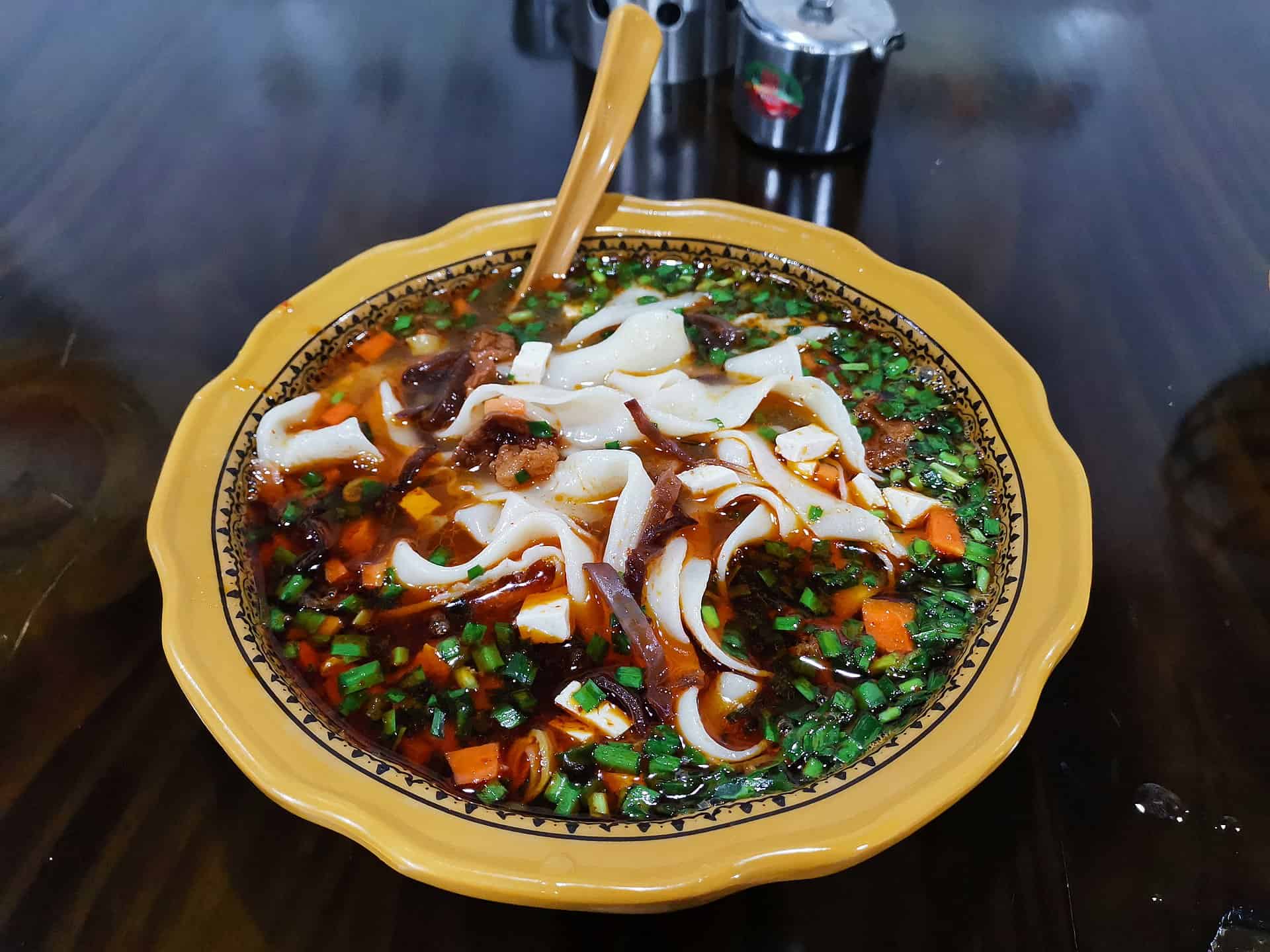 Qishan saozi noodles — thin noodles in a sour-hot broth with a fine dice of meat and vegetables
