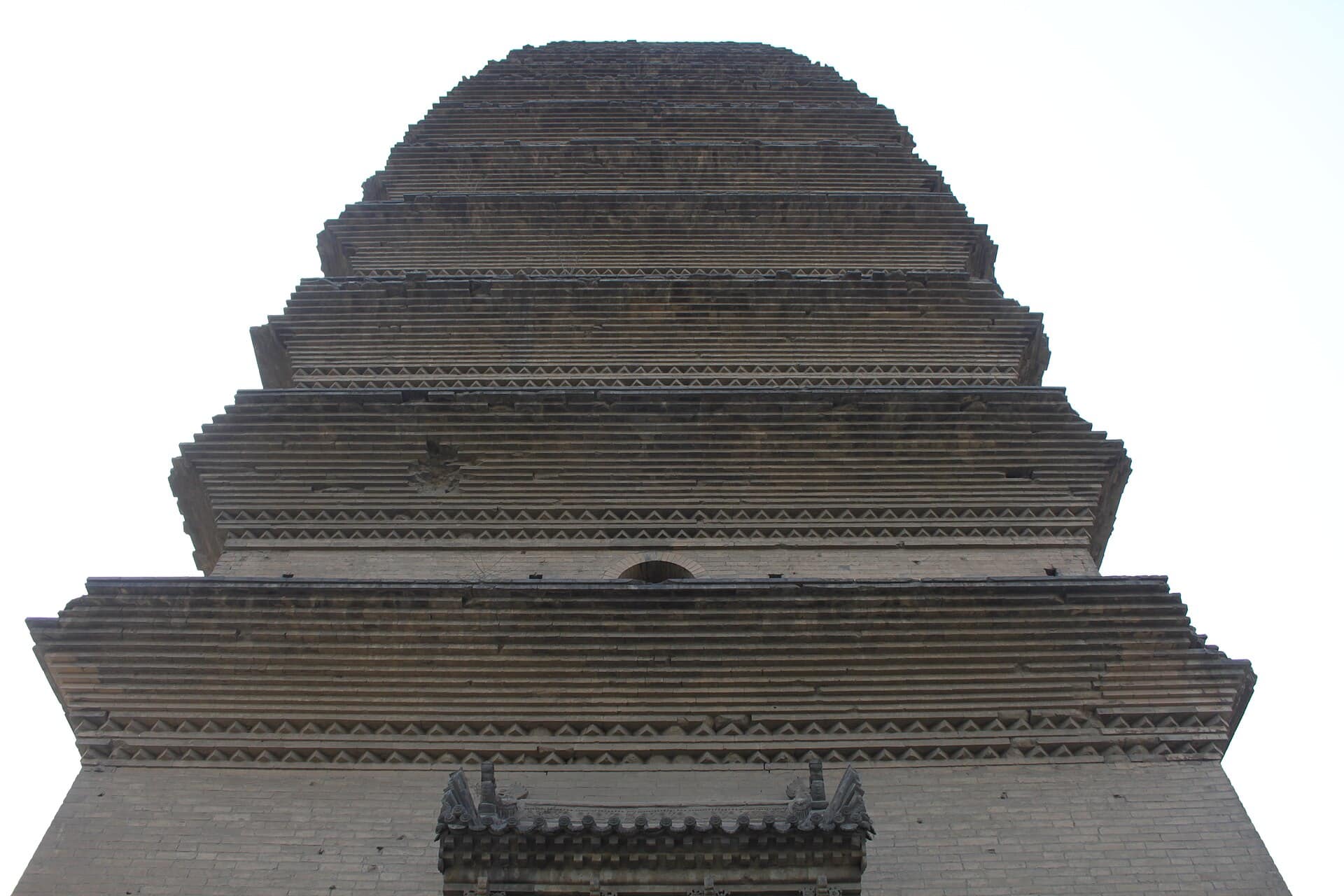 The Small Wild Goose Pagoda, a slender Tang-dynasty brick pagoda rising over courtyard trees in Xi'an