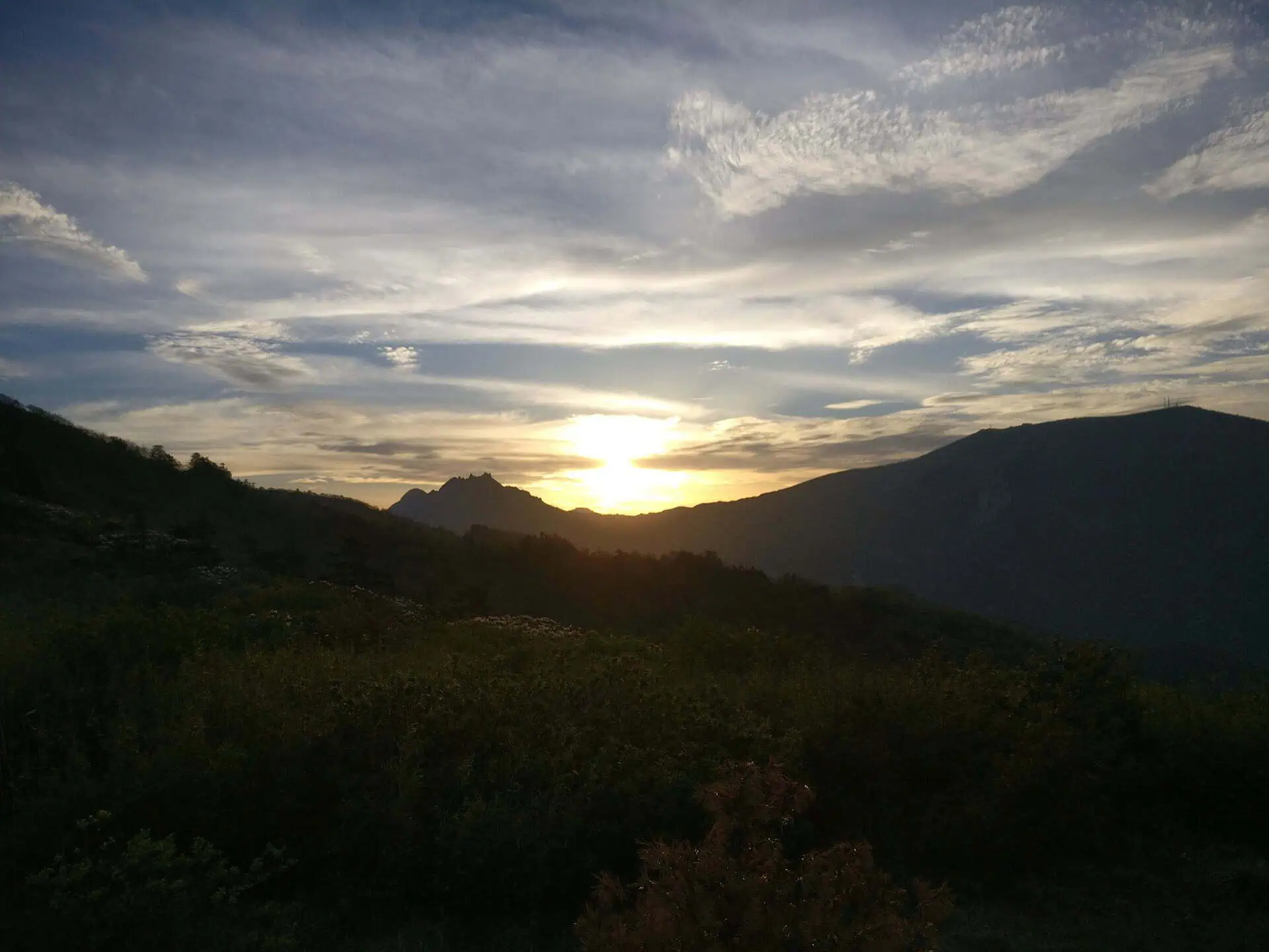 Sunset breaking over a dark forested ridge in the Qinling (Zhongnan) mountains south of Xi'an